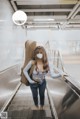 A woman wearing a face mask standing on an escalator.