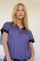 A woman in a purple shirt is posing for a picture.